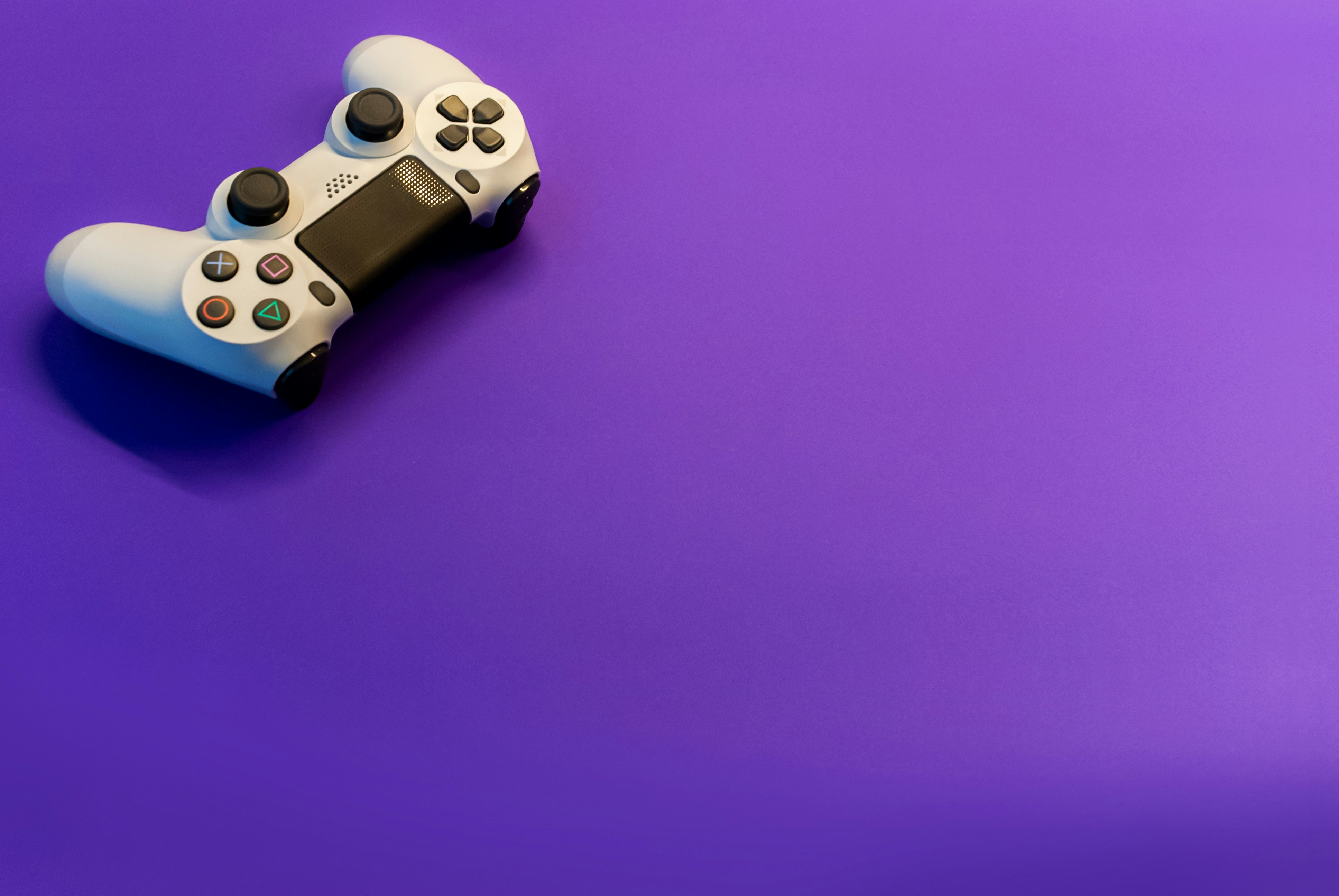 a PS4 dualshock with purple background